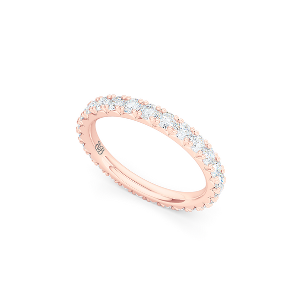 Classic French fishtail-set Diamond Eternity Wedding Ring. Hand-fabricated in Romantic Rose Gold and round brilliant diamonds. Free Shipping for All USA Orders.  BASHERT JEWELRY | Boca Raton, Florida