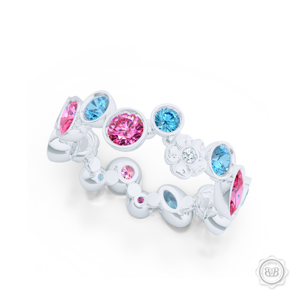 Unique Floral Motif Eternity Ring, Handcrafted in White Gold, Sky Blue Topaz, and Pink Tourmalines. Customize it with Birthstones or Anniversary gems of Your Choice. Free Shipping USA. 30Day Returns. BASHERT JEWELRY | Boca Raton, Florida