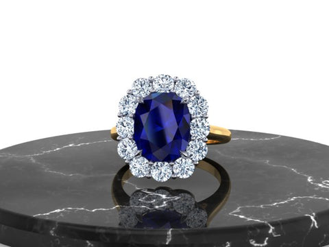 A custom-designed and fabricated heirloom halo ring, set in 18K Yellow Gold and Precious Platinum 950, showcasing a heirloom, cushion-cut Blue Sapphire* and a classic halo crown adorned with round brilliant diamonds.