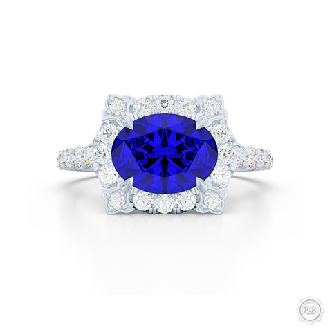 East-West Oval Blue Sapphire Halo Engagement Ring. Handcrafted in Precious Platinum or White Gold. Royal Blue Oval Sapphire. Vintage-inspired lines with a unique flower prong accents, adorned with Round Brilliant Diamonds. Free Shipping USA. 30-Day Returns | BASHERT JEWELRY | Boca Raton, Florida