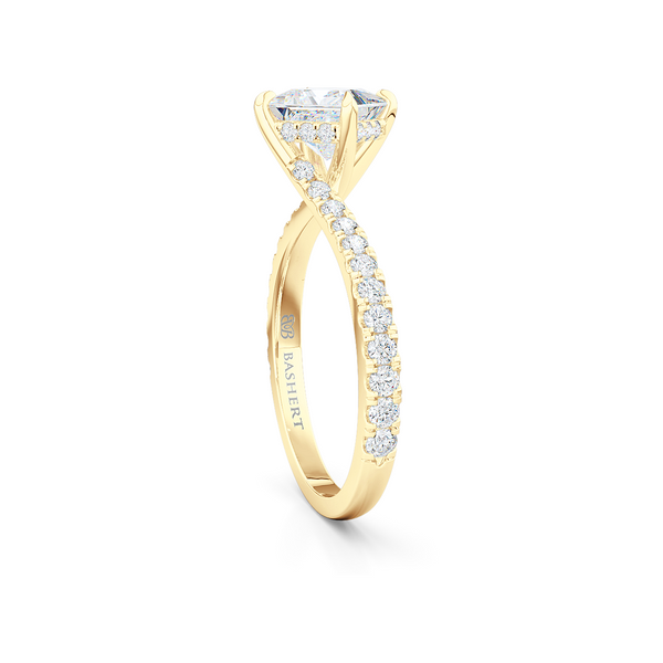 A unique, east-west princess cut Solitaire. Recessed diamond halo. Diamond-adorned shoulders. Hand-fabricated in Classic Yellow Gold. Available in GIA certified Diamond or Lab-Grown Diamond by Diamond Foundry. | Made in Boca Raton, Florida. 15 Day Returns. Free Shipping USA. | Bashert Jewelry 