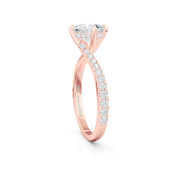 A unique, east-west princess cut Solitaire. Recessed diamond halo. Diamond-adorned shoulders. Hand-fabricated in Romantic Rose Gold. Available in GIA certified Diamond or Lab-Grown Diamond by Diamond Foundry. | Made in Boca Raton, Florida. 15 Day Returns. Free Shipping USA. | Bashert Jewelry 