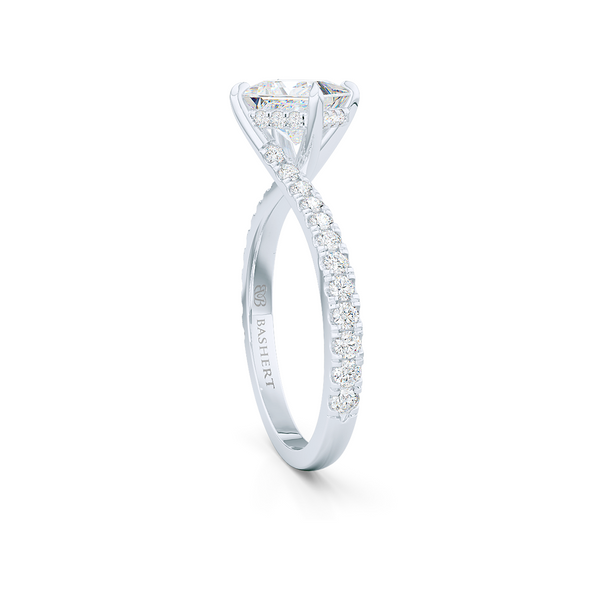 A unique, east-west princess cut Solitaire. Recessed diamond halo. Diamond-adorned shoulders. Hand-fabricated in White Gold or Precious Platinum. Available in GIA certified Diamond or Lab-Grown Diamond by Diamond Foundry. | Made in Boca Raton, Florida. 15 Day Returns. Free Shipping USA. | Bashert Jewelry 