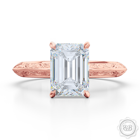 Signature Solitaire Engagement Ring featuring an Emerald Step Cut Forever One Moissanite by Charles & Colvard. Handcrafted in Romantic Rose Gold. The uniquely structured, soft bevel, shoulders of the ring are ornate with hand carved baroque swirls. Free Shipping for All USA Orders. 30-Day Returns | BASHERT JEWELRY | Boca Raton, Florida