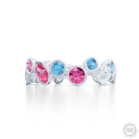 Unique Floral Motif Eternity Ring, Handcrafted in White Gold, Sky Blue Topaz, and Pink Tourmalines. Customize it with Birthstones or Anniversary gems of Your Choice. Free Shipping USA. 30 Day Returns. BASHERT JEWELRY | Boca Raton, Florida 