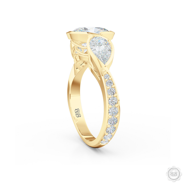 Three stone Moissanite engagement ring. Oval Cut Forever One Moissanite by Charles & Colvard. Pear shape side stone Moissanites. Handcrafted in Classic Yellow Gold. Free Shipping on All USA Orders. 30-Day Returns | BASHERT JEWELRY | Boca Raton, Florida